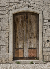 Fototapeta premium Medieval wooden door, adorned with stone