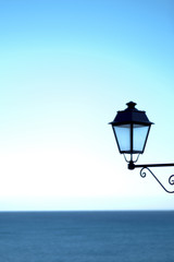un lampadaire murale avec la mer m&eacute;diterran&eacute;e en arri&egrave;re plan 