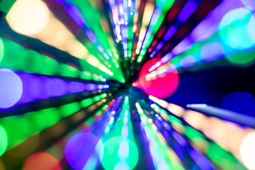Diagonal blurred lines of color lights is converged on dark background. Colorful lights blurred by motion.