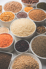 Uncooked pulses,grains and seeds in White bowls over white background. selective focus