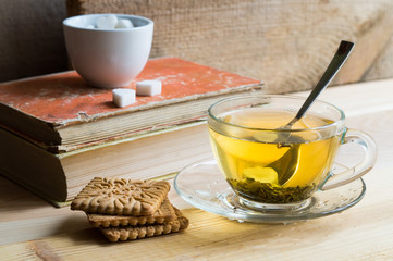 green tea in a glass dish with biscuits