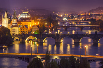 Fototapeta na wymiar Night view of famous european Prague city - the capital of Czech republic with reflection in river Vltava and historical bridges