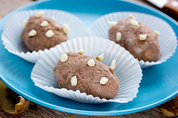 Homemade potato cakes in cocoa powder with cream sprouts