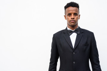 Young handsome African businessman wearing suit against white ba