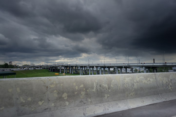elevated express way and road with cars. Dark stormy sky. A big rain is coming