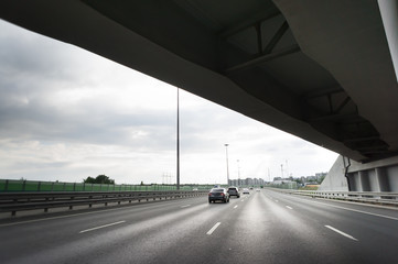 Highway interchange with bridge and cloudy sky