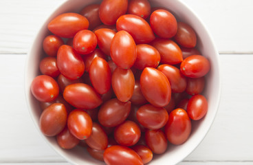 Grape Tomatoes in a White Bowl on a White Wood Table