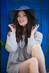 Portrait of beautiful young woman with makeup in black hat 