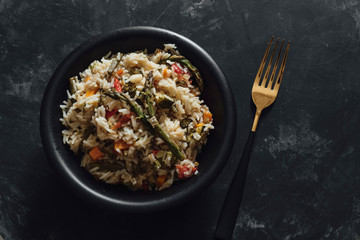 Basmati rice with sauteed vegetables on dark table