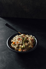 Basmati rice with sauteed vegetables on dark table