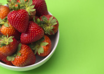 Bowl of Beautiful Red Strawberries on a Bright Green Table