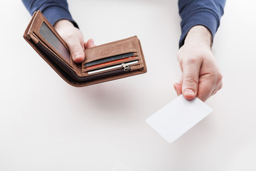 Man in suit with wallet and credit card