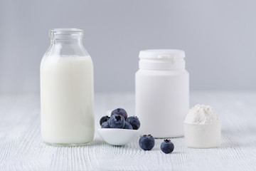 milk products and blueberrys on the table and gray background