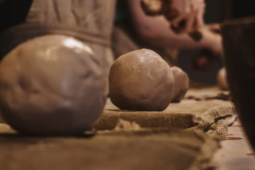 Making dirty hands of raw clay ware in a pottery workshop