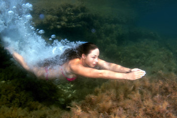 Fototapeta premium woman dives into the water, Black sea, Crimea, Ukraine, Europe
