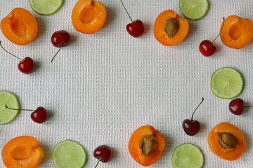 Apricot, lime and cherry slices top view of ripe fruit close-up.