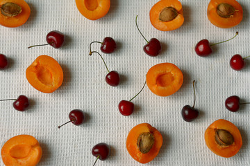 Apricots and cherries top view ripe fruit close-up.
