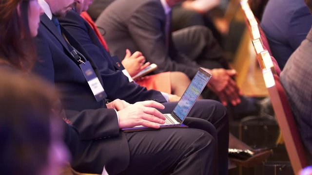Man working with laptop at a conference