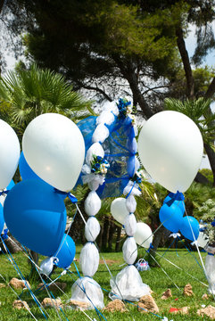 Wedding decoration blue and white ballons. Outdoor ceremony with floral composition and beautiful arhc.
