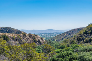 Suburbs of Southern California in the distance with view of mountains and smog cover