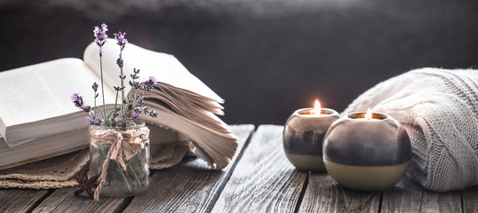 still life a book and a candle on a wooden table