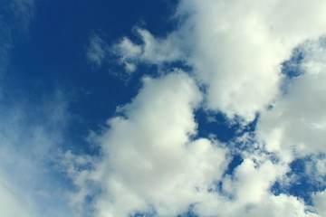Naklejka na ściany i meble Beautiful natural blue sky and white fluffy clouds. Background. Landscape.