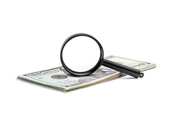 Magnifying glass with heap of money on white background.