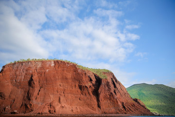 Red rocky coastline of Rabida Island in the Galapagos