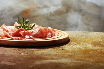 Italian prosciutto crudo or jamon with parsley. Raw ham