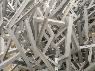 Chaotic ligament galvanized steel structures angular profile. Metal products in the industrial outdoors storage site. Industrial abstract background.
