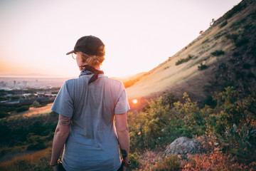 Girl hiking and looking at sunset