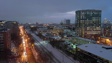 Naklejka premium Moscow night aerial shot along railways, late evening Russian capital cityscape street view.