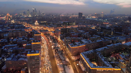 Fototapeta premium Aerial shooting of Moscow Garden Ring in the evening. City lights in the dusk. Business center 