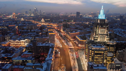Fototapeta premium Aerial shooting of Moscow Garden Ring in the evening. City lights in the dusk. Business center 