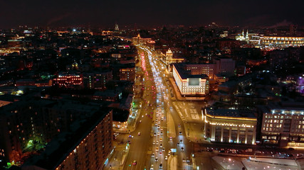 Fototapeta na wymiar Aerial shooting of Moscow Garden Ring in the late evening. City lights at night. Intensive traffic in downtown of Moscow.