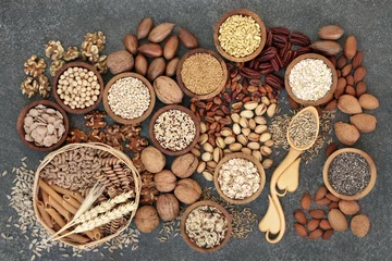 Poster Food with high fibre content for a healthy diet with whole wheat bread, whole grain pasta, nuts, seeds, legumes, grains and cereals. High in antioxidants, anthocyanins, vitamins & omega 3 fatty acids. © marilyn barbone
