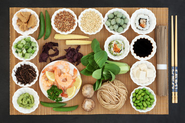 Macrobiotic Japanese food concept with seafood, sushi, miso and wasabi  paste & nuts, tofu, kuchika tea, vegetables, soba noodles, soy, tofu, with foods high in protein, antioxidants & vitamins. 