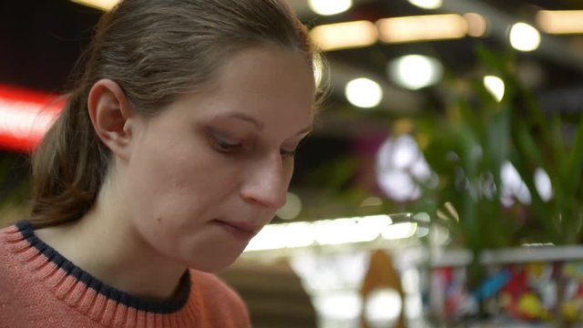 Pregnant woman eating cake at the mall cafe