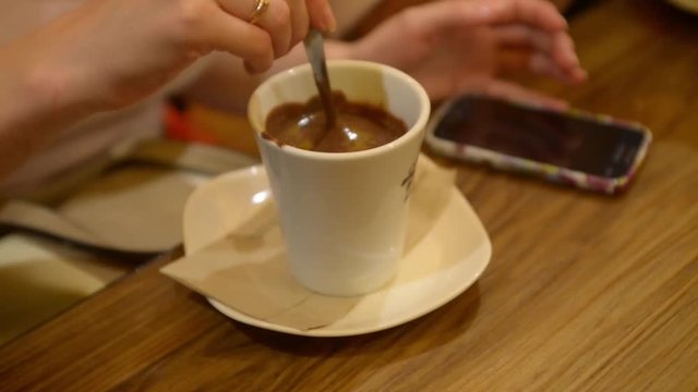 Cafe in Milan. Visitors drinking coffee eating hot chocolate
