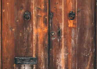 Texture of wooden brown old maltese door