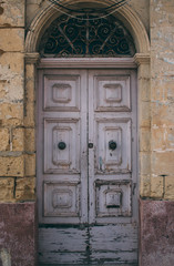 Fototapeta na wymiar Maltese old pink door, Malta