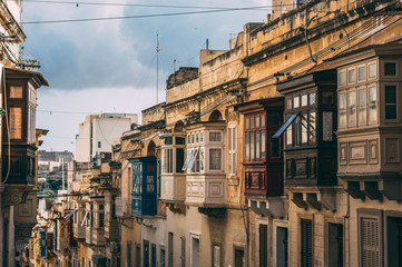 Fototapeta na wymiar Street view in Sliema, traditional balconies, Malta