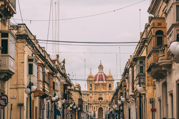 Fototapeta premium Stree view in Zabbar, Zabbar Parish Church, Malta