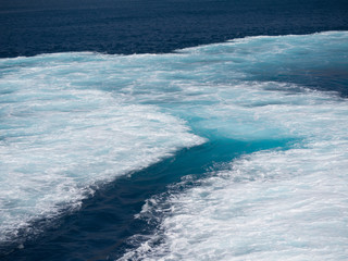 Close up of  the sea that is foaming due to the ship's engine