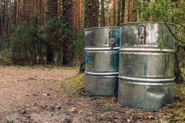 Garbage in big metal containers in nature, forest, at river as a concept of spring cleaning. Protecting ecology.