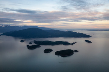 Aerial view of the Islands in Howe Sound during a vibrant sunset. Taken Northwest of Vancouver, British Columbia, Canada.
