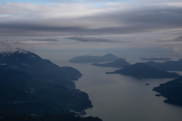Aerial view of Howe Sound during a cloudy evening. Taken near Squamish, North of Vancouver, British Columbia, Canada.