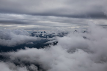 Aerial view of the striking Canadian Mountain Landscape covered in clouds. Taken North of Vancouver, British Columbia, Canada.