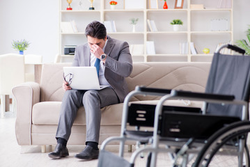 Dsabled businessman on wheelchair working home