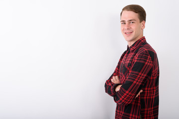 Young handsome man wearing red checkered shirt against white bac